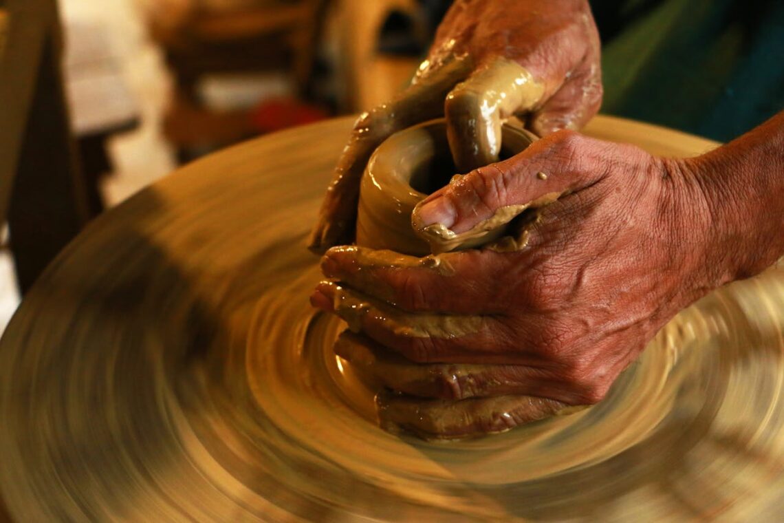 potter shaping a clay pot to represent the system molding a cop